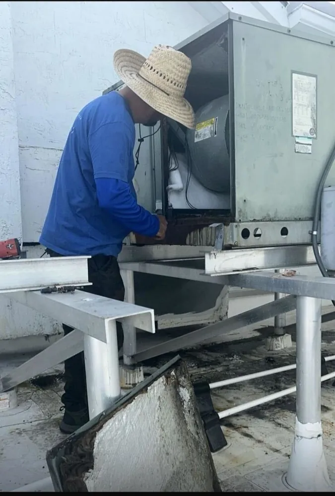 Cool Zone Engineering technician servicing an AC unit