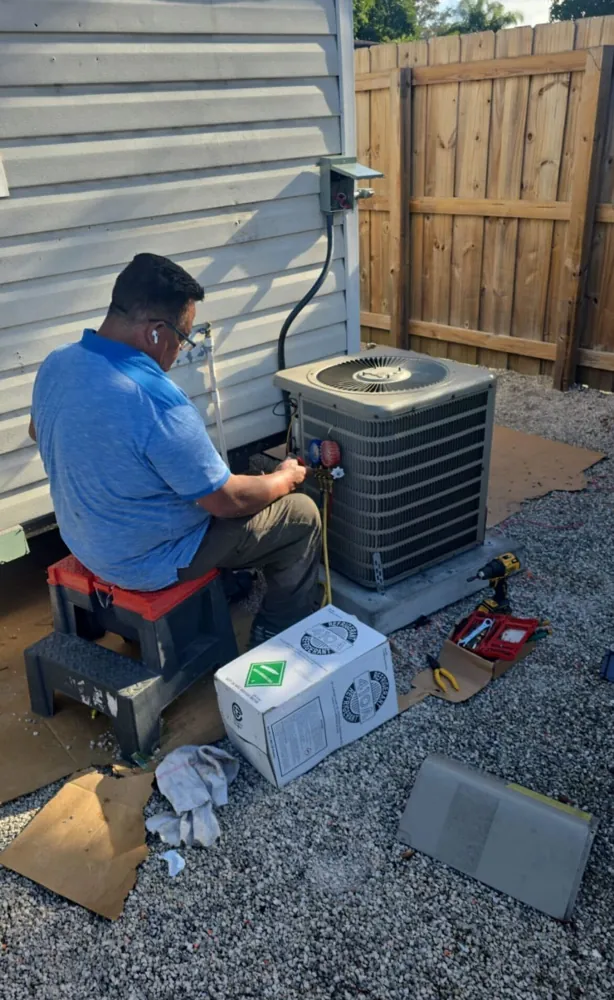 Cool Zone Engineering technician repairing an AC unit